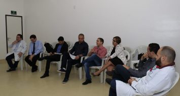 Comissão do curso de Medicina reunida em uma sala discutindo propostas para o melhoramento do curso.